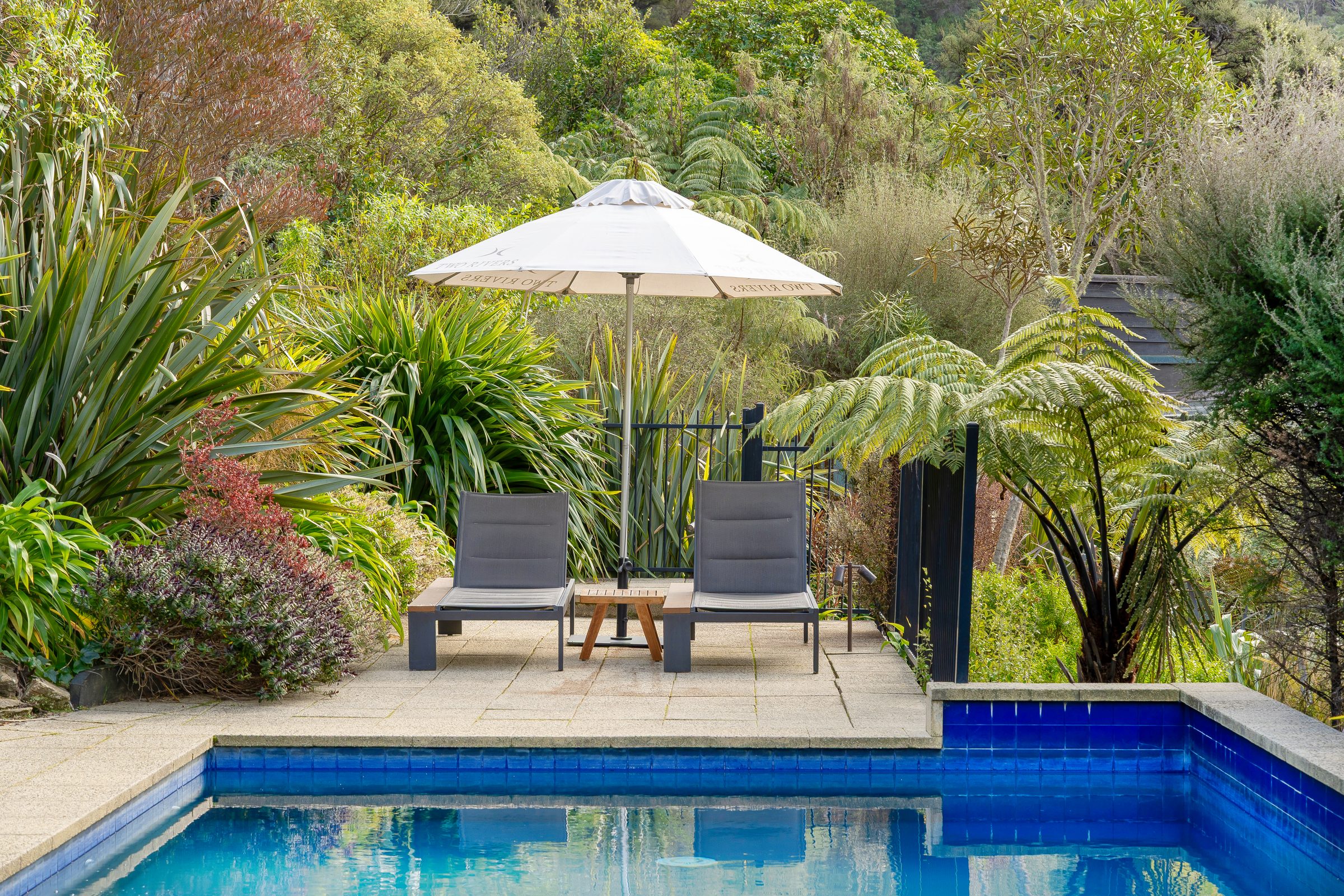 Poolside loungers among native bush