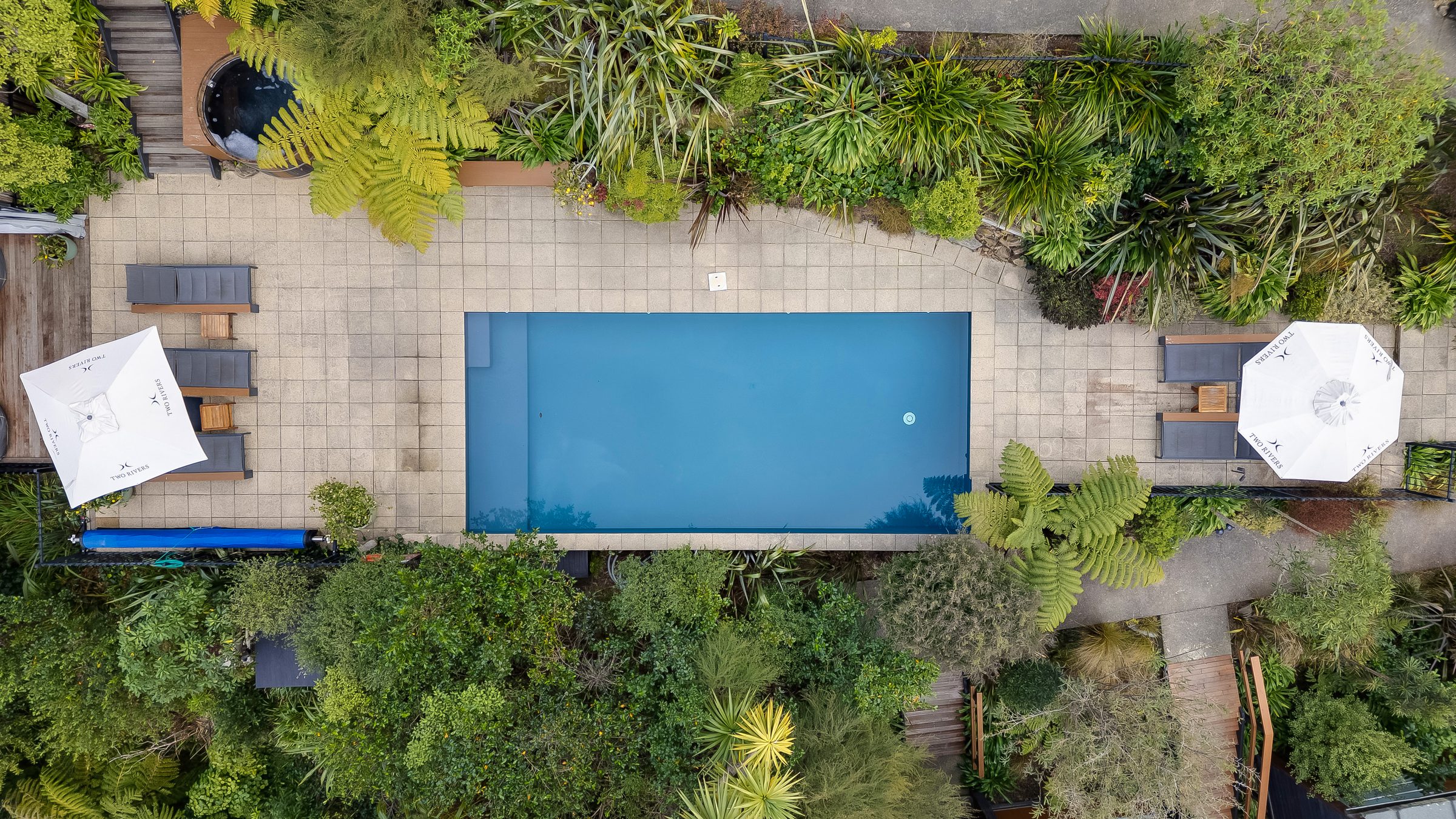 Aerial view of a lodge pool and gardens