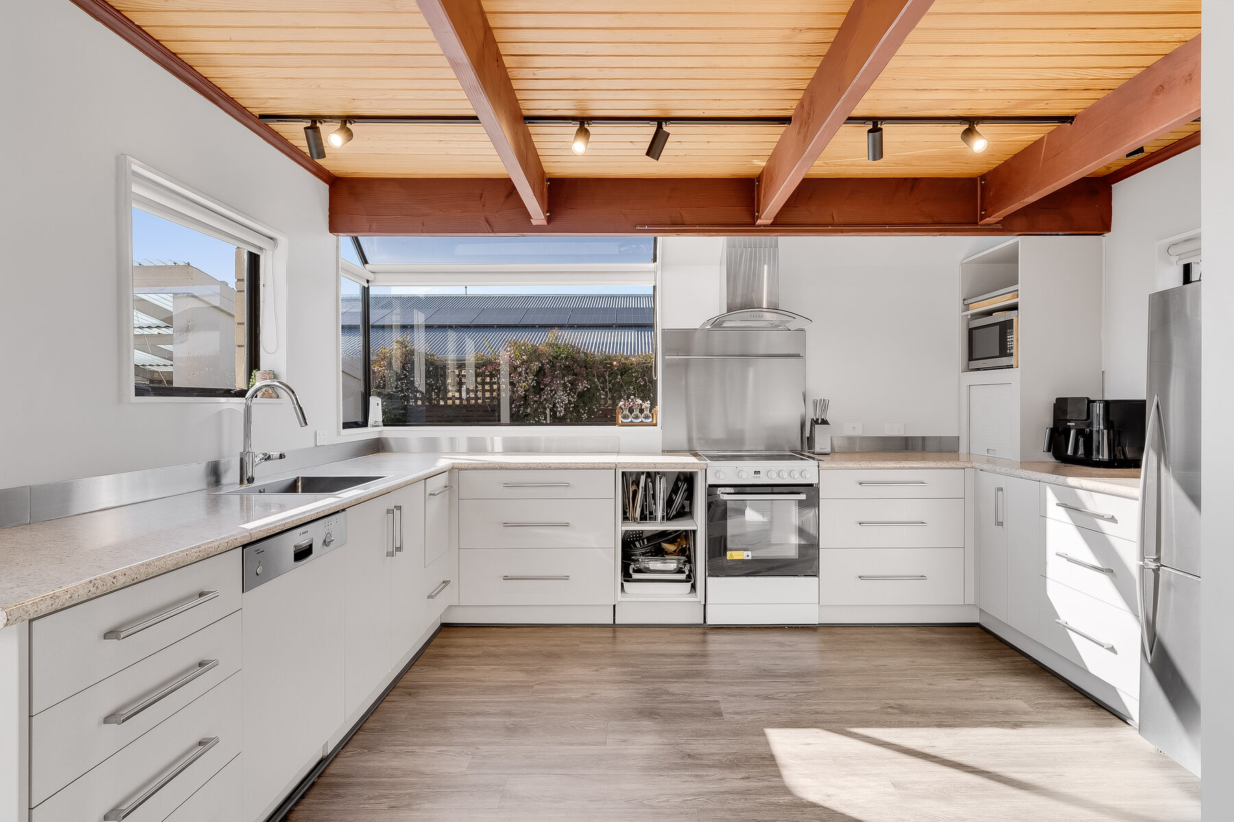 Kitchen with exposed timber beams and bush outlook