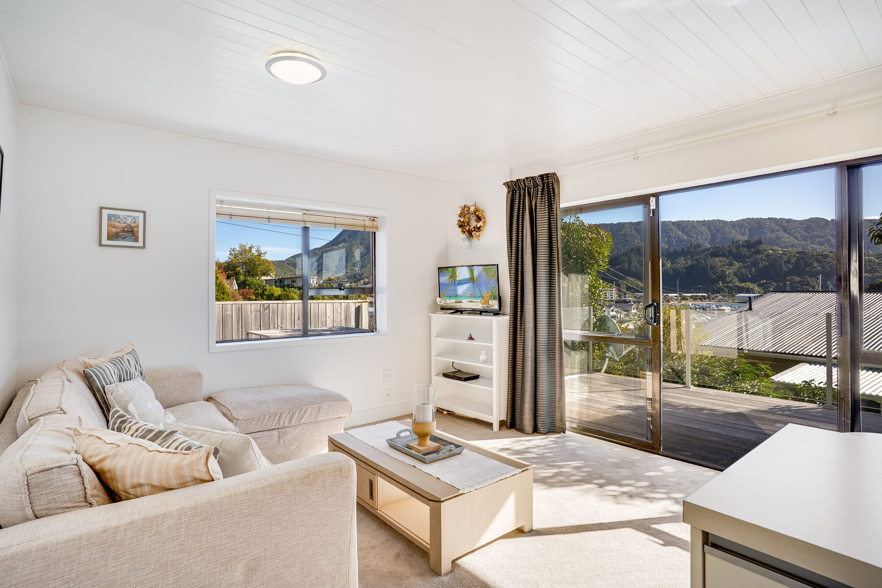 Sunlit living room with harbour and mountain views, Picton